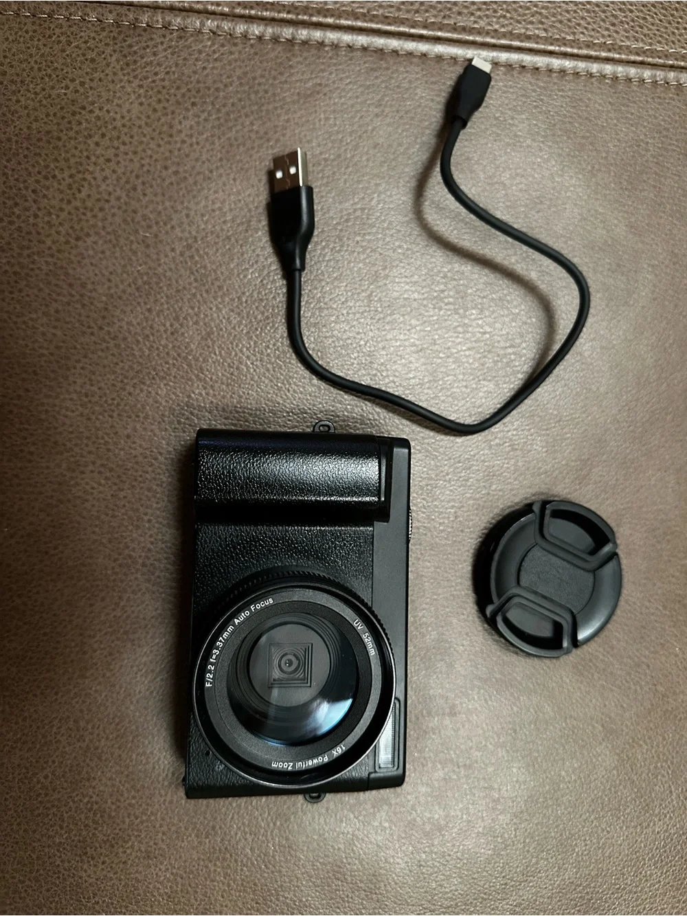 Compact Black Digital Camera with USB Cable and Lens Cap